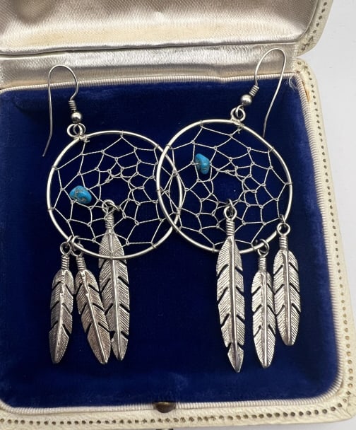 Pair Native American Sterling & Turquoise Earrings: Pair Native American Sterling & Turquoise Earrings. Sterling silver and tumbled turquoise bead dream catcher motif with feather pendants. Each measures just under 3.5 inches in length.