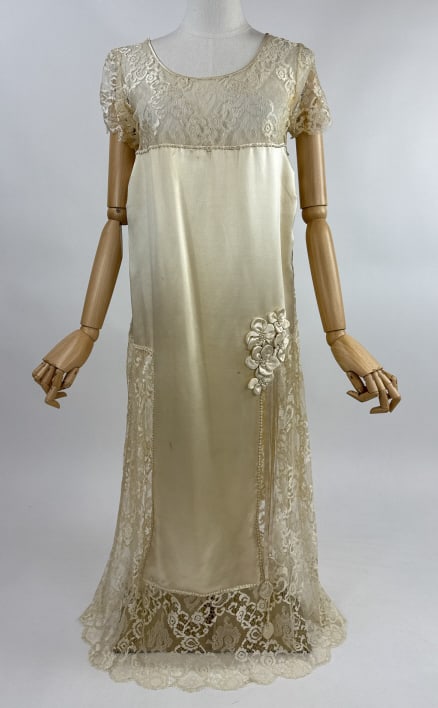 Antique 1920s Candlelight Silk Lace Wedding Gown: Antique 1920s Ivory Candlelight Silk Satin Lace Wedding Gown Dress. With pearl beads and floral appliques. Discoloration to underarms and small spots throughout. Snaps to close at side. Measures 36 bu