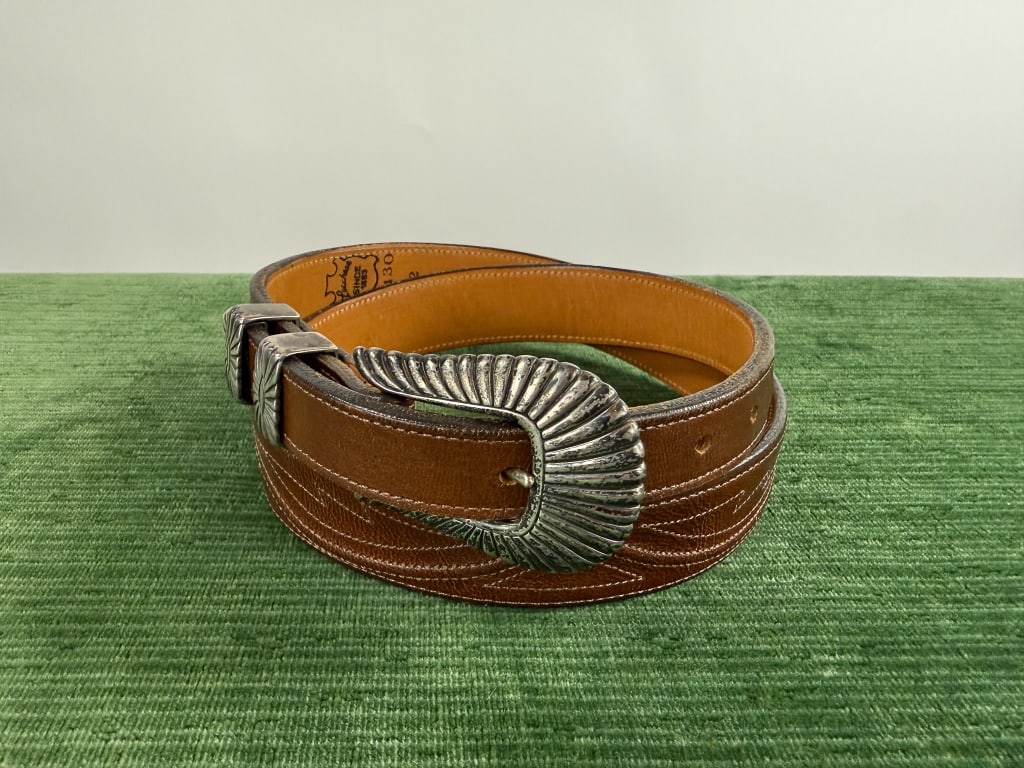 Vintage Lucchese Leather Sterling Silver Belt: Vintage Lucchese Brown Leather Western Sterling Silver Buckle Belt. Marked size 32. Sterling silver belt buckle and accents. Light wear as shown. Measures approximately 39 inches total length with hol
