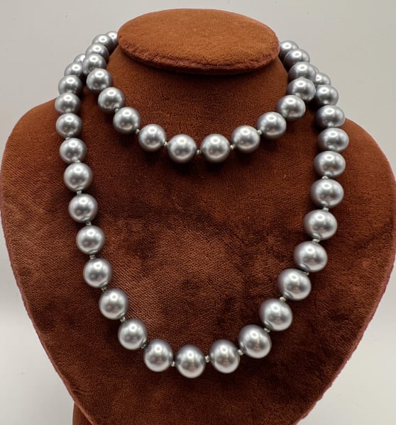 Estate Tahitian Cultured Pearl Necklace Strand: Estate Tahitian Cultured Pearl Necklace Strand. Hand knotted on silk thread, approximately 6mm silver tone cultured pearls, gold over silver navette clasp is hallmarked STERLING. Measures approximatel