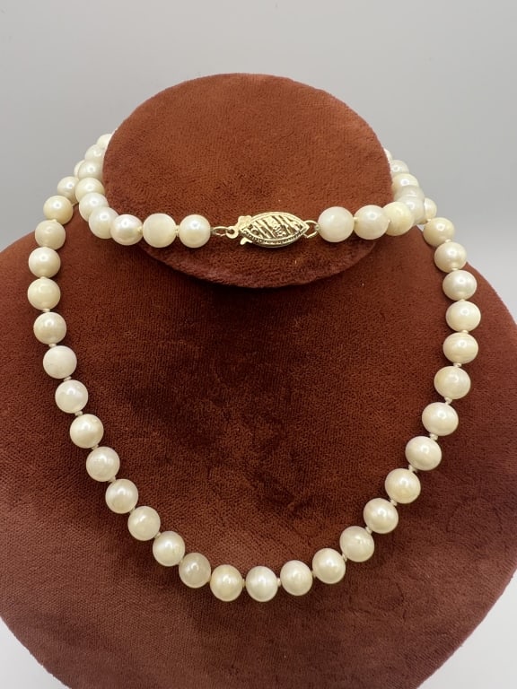 Estate 14kt Yellow Gold & Cultured Pearl Necklace: Estate 14kt Yellow Gold & Cultured Pearl Necklace Strand. Hand knotted on silk thread. 14kt yellow gold filigree design clasp. Hallmarked. Pearls with some wear. Measures 19 inches in length.