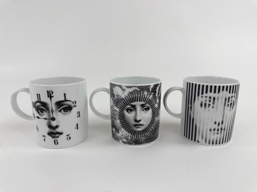 Group of Three Pietro Fornasetti Porcelain Mugs: Group of Three Pietro Fornasetti Porcelain Mugs. All three are marked Rosenthal on the bottoms. Each measures 3.5 inches in height, 4.5 inches in width with handle, 3 inches in diameter without handle