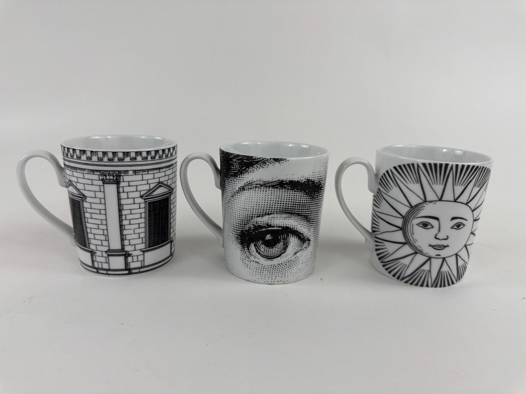 Group of Three Pietro Fornasetti Porcelain Mugs: Group of Three Pietro Fornasetti Porcelain Mugs. All three are marked / signed on the bottoms. Each measures 3.5 inches in height, 4 inches in width with handle, 3 inches in diameter without handle.