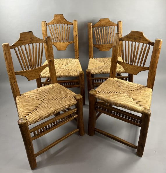 Adirondack Style Rough Hewn Log Dining Chairs: Set of Adirondack Style Rough Hewn Log Dining Chairs. With handmade rush seats. Each side chair measures approximately 38 inches in height, 21 inches in width, 18 inches in depth. From a Lake