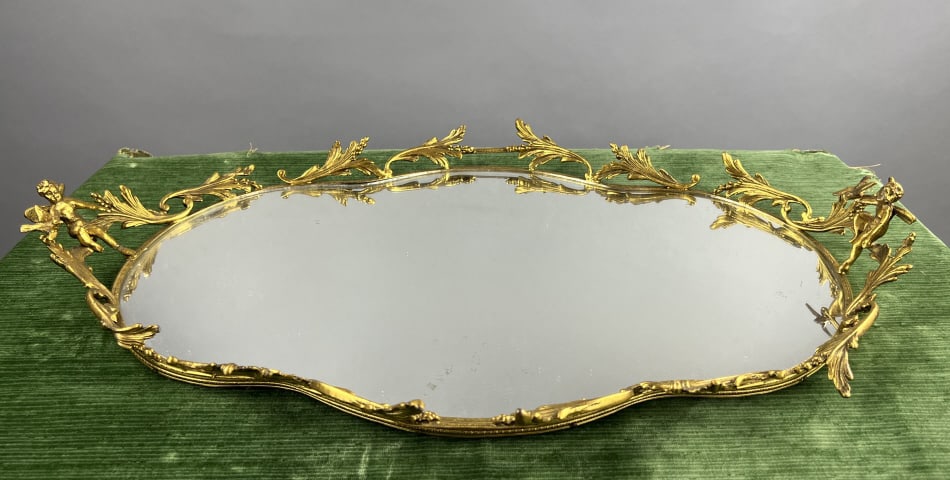 Antique Figural Gilt Ormolu Gallery Mirrored Tray: Antique Figural Gilt Ormolu Gallery Mirrored Tray w Cherubs. Measures approximately 4.5 inches in height and tray measures 23 x 15.5 inches.