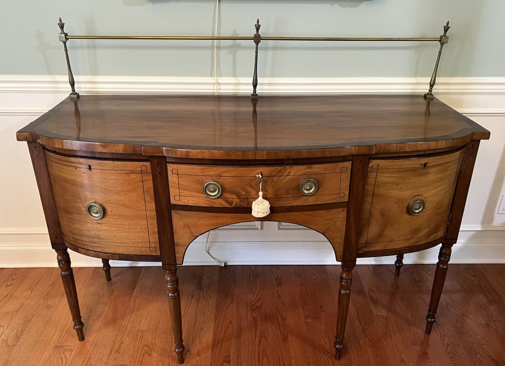 Antique 19th C Hepplewhite Bowfront Sideboard: Antique 19th C Hepplewhite Bowfront Sideboard or Buffet. Having a gilt brass gallery at back. Dovetailed drawers, brass repousse hardware, banded border, inlaid drawer fronts, turned legs. Measures 37