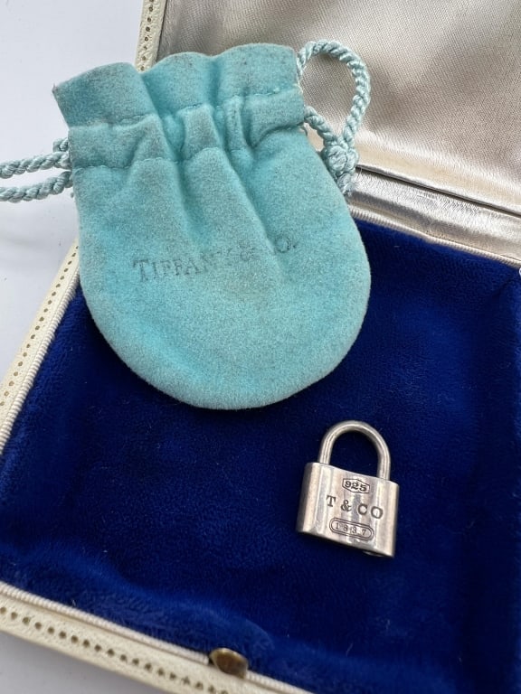 Vintage Tiffany & Co Sterling Silver Padlock Charm: Vintage Tiffany & Co Sterling Silver Padlock Charm. Signed and hallmarked. Comes with branded Tiffany & Co dust cover. Padlock measures approximately .75 of an inch in length.