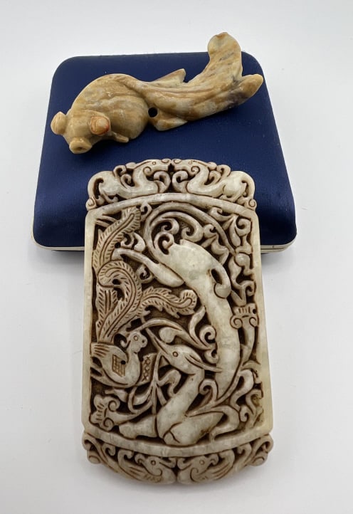 Two Chinese Carved Jade Necklace Pendants: Two Chinese Carved Jade Necklace Pendants. One in the design of a koi fish and other larger scale with dragons and phoenix in scrollwork. Larger measures 3.5 x 2 inches.