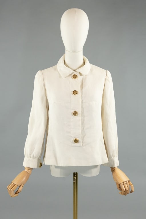 Vintage 1960s Geoffrey Beene White Linen Blouse: Vintage 1960s Geoffrey Beene White Linen Blouse. Long sleeves that button at cuffs, missing one. Buttons down front to close. Silk lined. Measures 36 inch bust, 22 inches long, 20 inch sleeve length.