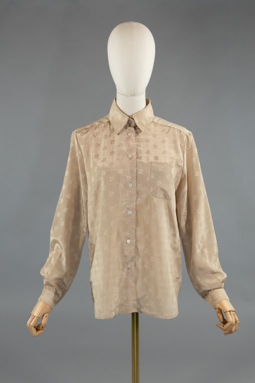 Vintage 1980s Pierre Cardin Logo Button Up Shirt: Vintage 1980s Pierre Cardin Logo Button Up Shirt. Buttons up front to close with single breast pocket. 100% polyester, marked size 12. Measures 20 inches flat across chest, 26 inches long, 23 inch