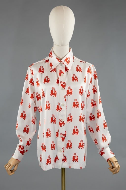 Vintage 1970s Lanvin Lion Print Button Up Shirt: Vintage 1970s Lanvin Lion & Logo Print Button Up Shirt. Buttons up front to close. Marked size 14. Measures 21 inches flat across chest, 26 inches long, 24 inch sleeve length.