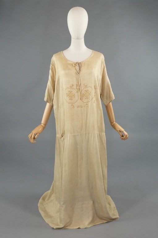 Vintage 1920s Beige Pongee Silk Embroidered Dress: Vintage 1920s Beige Pongee Silk Embroidered Folk Shift Tent Dress. With tie at neck. Loose oversized fit. Embroidered at chest and sleeves. Single pocket at drop waist seam. Light wear throughout as
