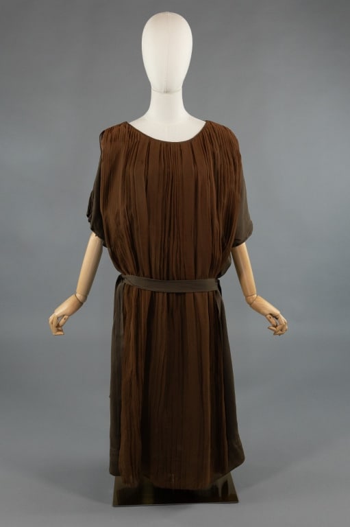 Vintage 1920s Brown Silk Pleated Shift Dress: Vintage 1920s Brown Silk Pleated Shift Dress. With pleating throughout front and back. Attached belt at drop waist. Snaps at shoulders. Light wear throughout as shown. Measures 44 inch bust, 44 inch