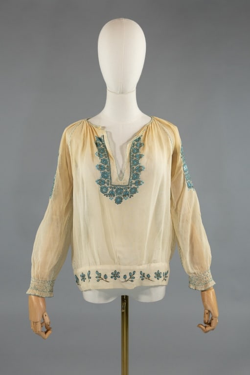 Vintage 1930s Embroidered Peasant Folk Blouse Top: Vintage 1930s Beige Embroidered Peasant Folk Blouse Top. Floral embroidered throughout with smocked cuffs on sleeves. Light wear throughout as shown. Measures 21 inches flat across chest, 21 inches