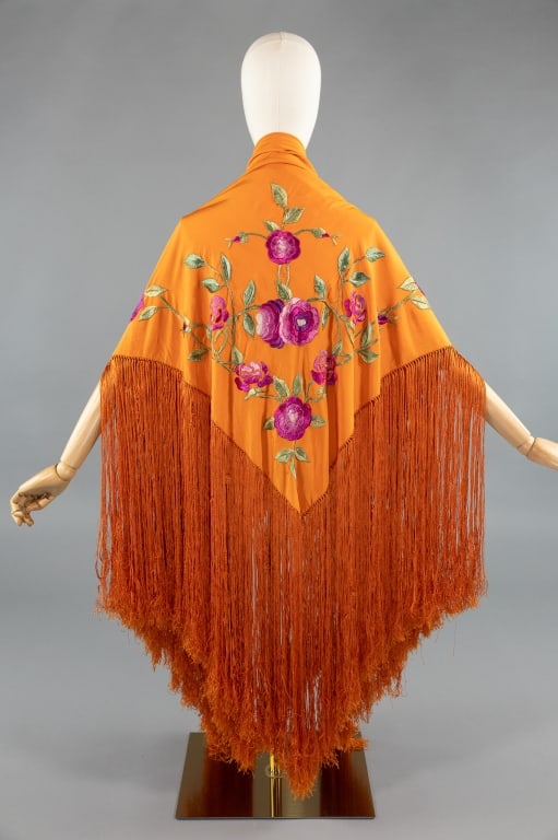 Antique 1920s Silk Floral Embroidered Piano Shawl: Antique 1920s Orange Silk Floral Embroidered Fringed Piano Shawl. Light wear throughout with purple, pink, and green floral embroidery in one corner. Measures approximately 43 inches by 45 inches with
