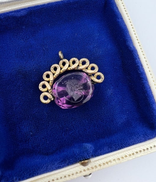 Antique 19th C Victorian Amethyst Fob Spinner: Antique 19th C Victorian Amethyst Fob Spinner. Watch chain fob or necklace pendant. Set with a faceted and intaglio carved amethyst that spins within the setting. Measures 1.25 inches in width.
