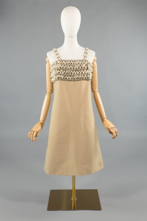 Vintage 1960s Simone Boutique Embellished Dress: Vintage 1960s Simone Boutique Silk Paliette Embellished Dress. Fully embellished at bust with a-line shape and center back zip closure. Light wear throughout as shown, small spot at hem. Measures 36 i