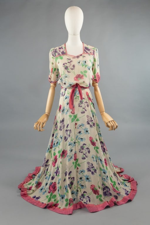 Vintage 1940s Silk Chiffon Floral Print Gown: Vintage 1940s Silk Chiffon Floral Print Gown. Puff sleeves with dramatic sweep in skirt. Zips at side to close with attached belt at waist. Hem is trimmed in pink taffeta. Light wear as shown, notably