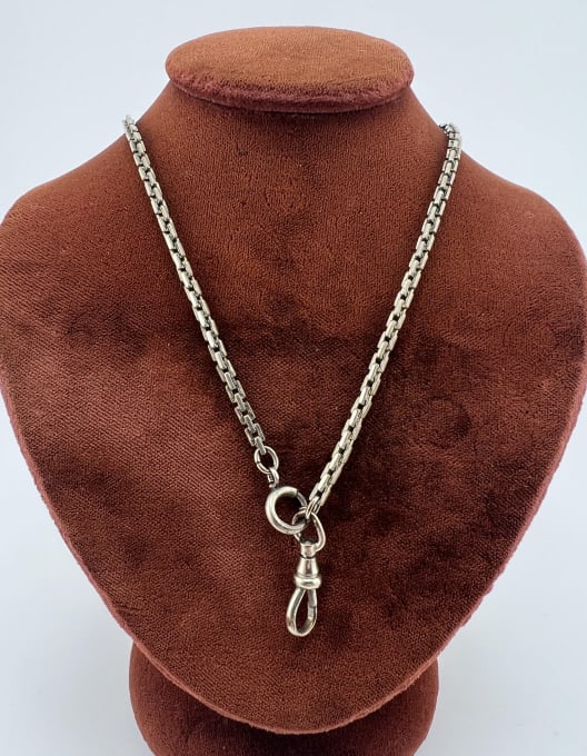 Antique Art Deco White Gold Filled Watch Chain: Antique Art Deco White Gold Filled Watch Chain. Set with dog clip and spring ring. White gold filled or silver plated, clasp is only marked SIMMONS. Measures 16 inches in length.