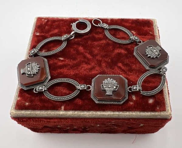 Antique Art Deco Sterling & Carnelian Bracelet: Antique Art Deco Sterling & Carnelian Bracelet.Art Deco Articulated Sterling Silver panel bracelet, having three panels of sterling framed carnelian that feature marcasite set floral displays at cente