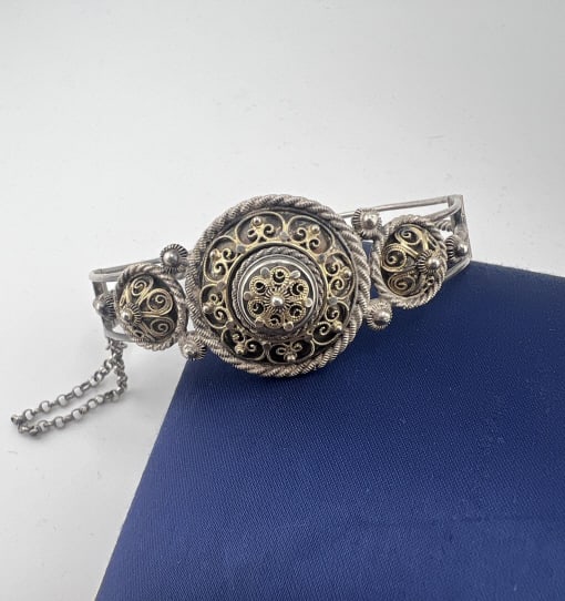 Antique Silver Filigree Hinged Bangle Bracelet: Antique Silver Filigree Hinged Bangle Bracelet. Ornate filigree, wirework, cannetille bracelet. Hinged bangle bracelet with safety chain. Measures 2.5 inches across the interior opening.