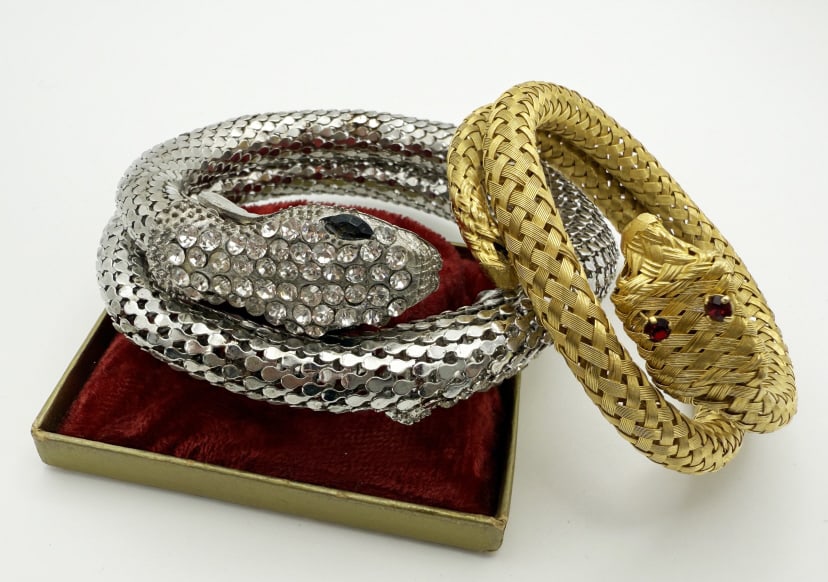 Pair of Vintage Metal Snake Wrap Bracelets: Pair of Vintage Metal Snake Wrap Bracelets. Two bracelets - one silver tone snake with rhinestones on head and tail & one gold tone snake with red rhinestone eyes. Adjustable with stretch throughout b