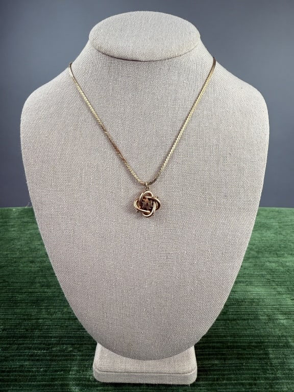 Antique Gold Fill Love Knot Pendant Necklace: Antique Victorian Gold Fill Love Knot Pendant Necklace. Star on each side with garnet cabochons. Pendant measures 1 inch including bail, chain measures 22 inches long and is marked gold filled.