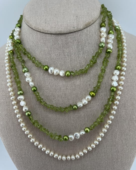 Sterling Silver Baroque Pearl Peridot Necklaces: Sterling Silver Baroque Pearl Peridot NecklacesHand knotted baroque pearl necklace strand with sterling silver clasp. Measures 21 inches in length. Necklace with white and gold tone baroque pearls and