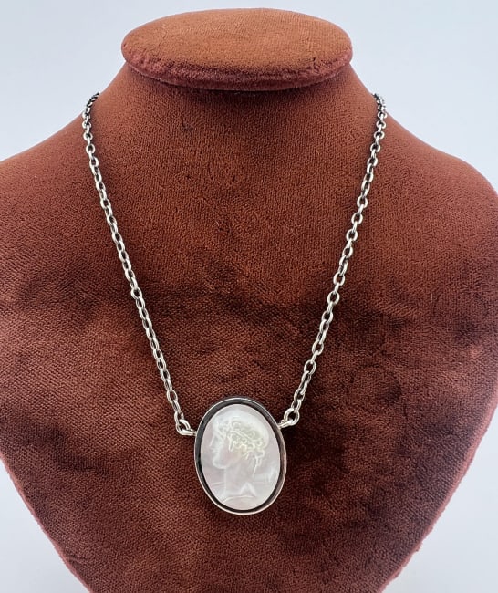 Estate Sterling & Mother of Pearl Cameo Necklace: Estate Sterling & Mother of Pearl Cameo Necklace. Sterling silver necklace with hand carved Greco Roman style mother of pearl portrait cameo. Measures 16 inches in length.