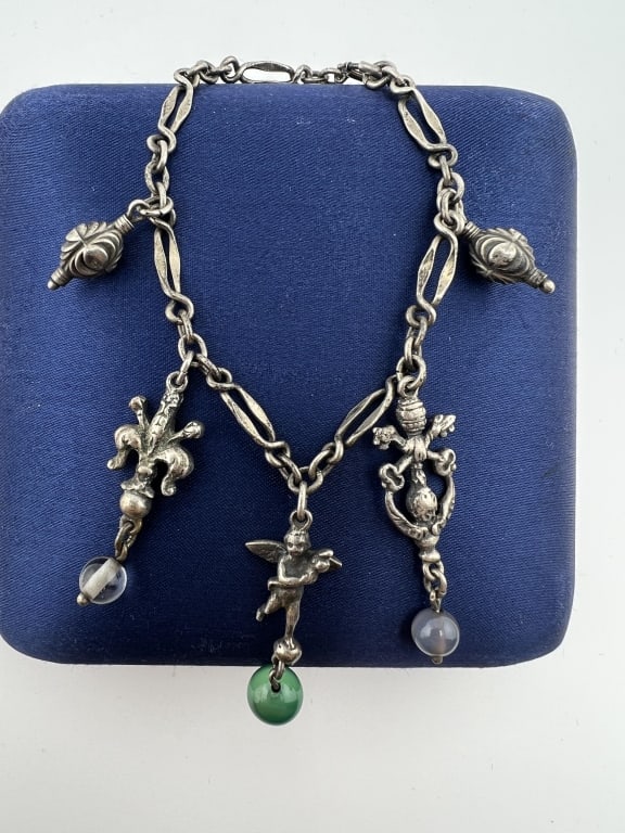Antique Italian Sterling Peruzzi Charm Bracelet: Antique Italian Sterling Silver Peruzzi Charm Bracelet. Set with five figural charms and green onyx beads. Measures 6.75 inches in length.