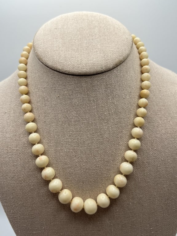 Antique Graduated Angel Skin Coral Bead Necklace: Antique Graduated Angel Skin Coral Bead Necklace. Hand knotted on silk thread, set with graduated size natural coral beads. Measures 17 inches in length.