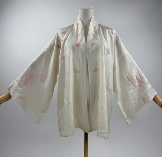 Antique Asian Butterfly Embroidered Silk Robe: Antique Asian Butterfly Embroidered Silk Robe. Possibly Japanese in origin. White silk satin ground with pink embroidered silk butterfly design throughout. No closures, open front. Chest measures 25 i