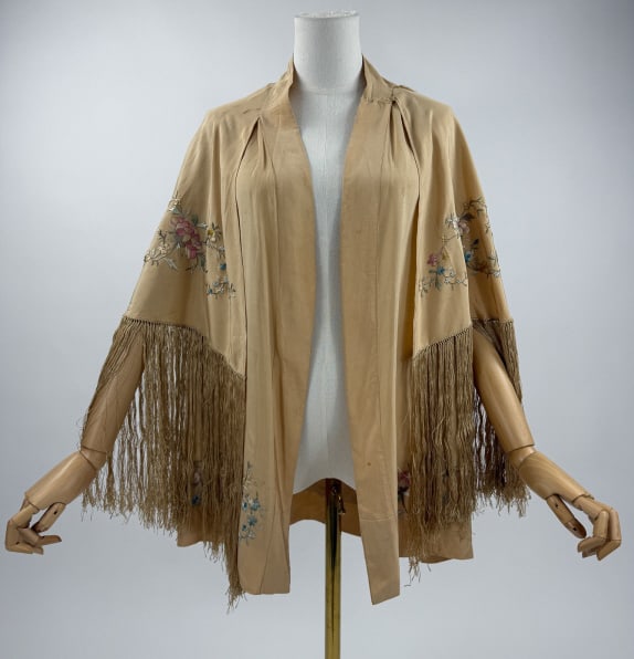 Antique Chinese C 1920s Piano Shawl Silk Cape: Antique Chinese C 1920s Piano Shawl Silk Cape. Beige silk ground with polychrome pastel silk floral embroidery. Sleeve less body with fringed cape connected at shoulders. Repair at high shoulder point