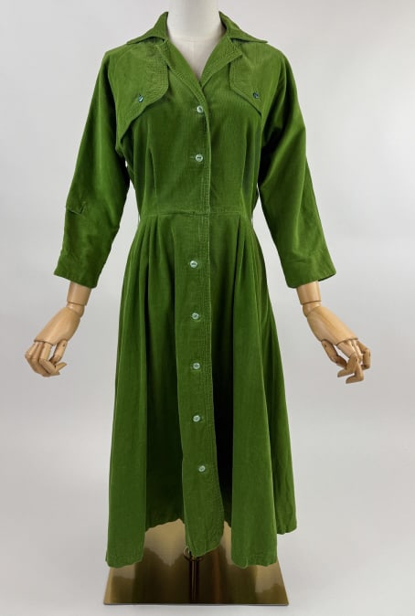 Vintage 1950s Corduroy Circle Skirt Shirt Dress: Vintage 1950s Green Corduroy Rockabilly Pinup Button Front Circle Skirt Shirt Dress. Notched collar with buttoned flaps at front. Buttons down front to close. Circle skirt with pockets at side. Tear a