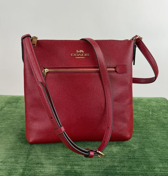 Coach Red Leather w Gold Hardware Purse: Coach Red Leather w Gold Hardware Purse. Rowan File Cross Body Bag. With zippered pocket at front, interior pocket, adjustable cross body strap. Measures 10 x 10 x 1.5 inches, plus strap.
