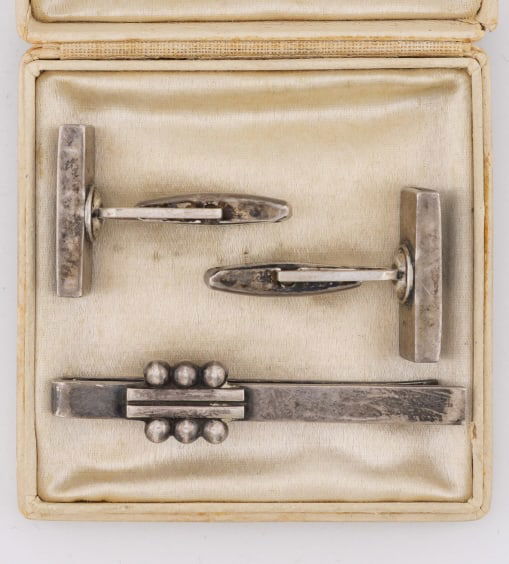 Estate Georg Jensen Sterling Clip & Cuff Links: Estate Georg Jensen Sterling Silver Clip & Pair of Modernist Sterling & Wood Cuff Links. Clip is signed for Georg Jensen, cuff links are hallmarked for sterling. Clip is 2 inches in length, cuff links