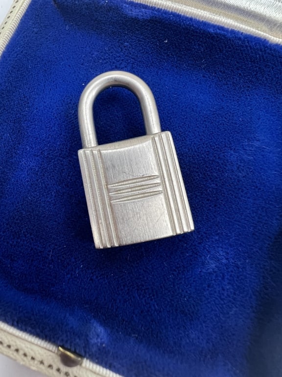 Vintage Hermes Silver Tone Birkin / Kelly Padlock: Vintage Hermes Silver Tone Birkin / Kelly Padlock. Stamped HERMES and 111. No key included. Measures 1.5 inches in length. Great as a necklace pendant.