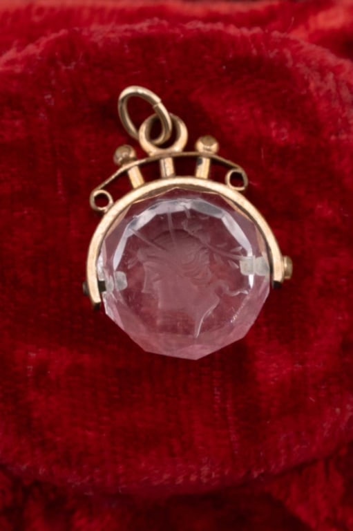 Antique 19th C Crystal Intaglio Spinner Pendant: Antique 19th C Crystal Intaglio Spinner Pendant. Victorian era yellow gold filled spinner fob pendant with Greco Roman style soldier intaglio on faceted crystal. Measures 1 inch in length.