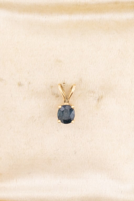 Estate 14kt Yellow Gold Sapphire Solitaire Pendant: Estate 14kt Yellow Gold Sapphire Solitaire Pendant. Hallmarked 14k on the back. Measures 3/8ths of an inch in length.