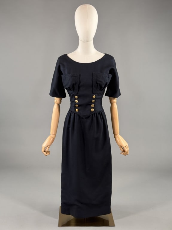 Vintage 1950s Oleg Cassini Wool Button Front Dress: Vintage 1950s Oleg Cassini Wool Button Front Dress having oversized pockets at bust with non-functional buttons at waist yoke and zip closure down center front. Measuring 34 - 36 inch bust, 25 - 26 in