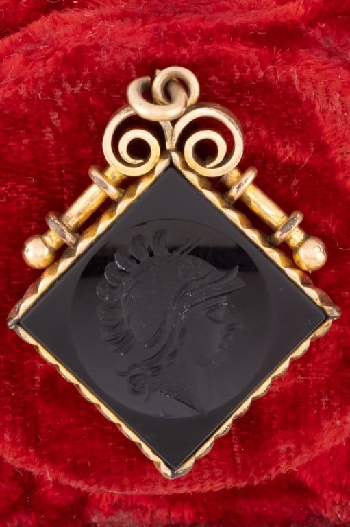 Antique 19th C Carved Onyx Intaglio Fob Pendant: Antique 19th C Carved Onyx Intaglio Fob Pendant. Victorian era carved black onyx Greco Roman style intaglio in yellow gold filled setting. Measures just over 1.5 inches in length.