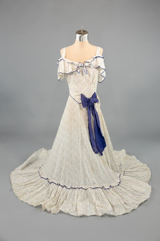 Vintage 1930s Floral Swiss Dot Bow Gown Dress: Vintage 1930s Floral Swiss Dot Bow Gown Dress having cold shoulder with ruffled sleeve and bow detail at front. Closing at side with snaps, light wear as shown. Measuring 32 inch bust, 22 inch waist,