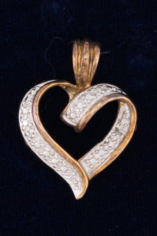 Gold Over Sterling Silver Diamond Heart Pendant: Gold Over Sterling Silver Diamond Heart Pendant. Hallmarked. Heart form necklace pendant with diamond accents. Measures just over 1 inch in length.