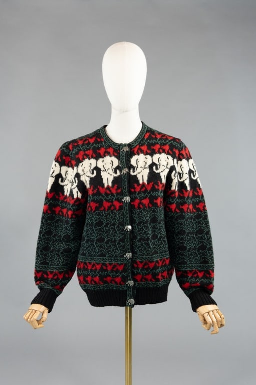 Vintage 1980s Wool Elephant Cardigan Sweater: Vintage 1980s Wool Elephant Cardigan Sweater having elephant print design throughout and metal elephant shaped button closure down center front. Labeled Blueberry Woolens. Measuring 38 inch bust, 28 i