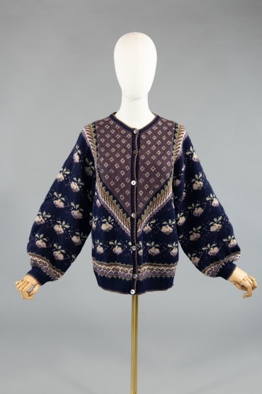 Vintage 1980s Carrie Knit Wool Cardigan Sweater: Vintage 1980s Carrie Knit Wool Cardigan Sweater having print throughout and button closure down center front. Measuring 40 inch bust, 26 inches long, 25 inch sleeve length with stretch throughout.