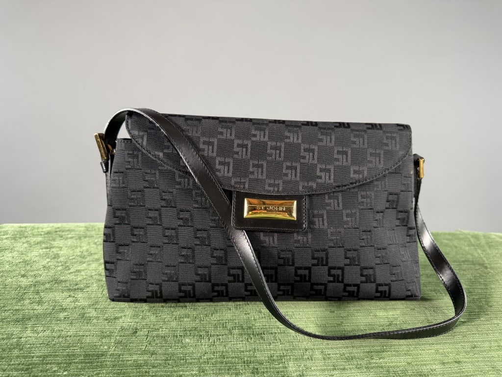 Vintage 1990s St. John Monogram Shoulder Bag Purse: Vintage 1990s St. John Monogram Shoulder Bag Purse having monogram logo print throughout with metal logo snap closure. Single interior zippered pocket and adjustable shoulder strap. Measuring approxim