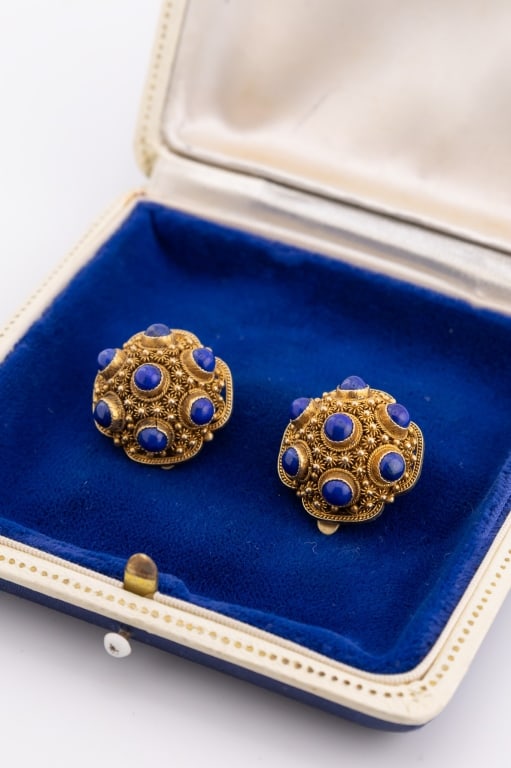 Estate Gold Over Silver Lapis Etruscan Earrings: Estate Gold Over Silver Lapis Etruscan Earrings. Clip on earrings in gold over silver filigree and cannetille wirework with lapis lazuli cabochons. Each measures .75 of an inch in diameter.