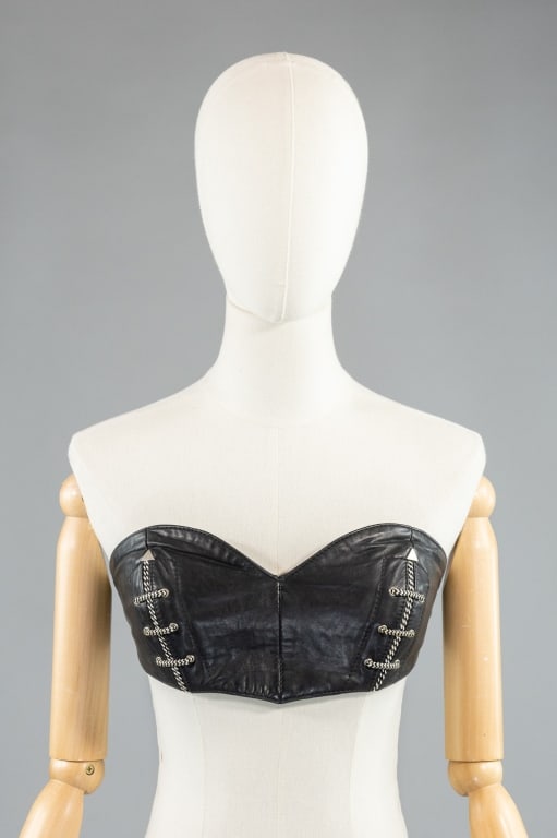 Vintage 1988 Michael Hoban North Beach Leather Bra: Vintage 1988 Michael Hoban North Beach Leather Bra having exposed stitching at cups with elastic back and snap closure. One snap missing stone as shown. Marked size S - measuring 28 - 32 bust, 6 inche