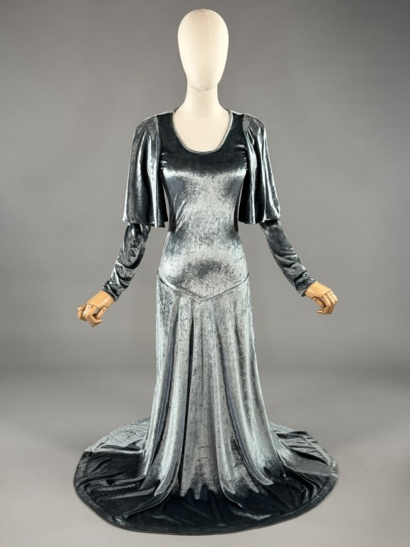 Vintage 1970s Janice Wainwright Velvet Jersey Gown: Vintage 1970s Janice Wainwright Velvet Jersey Gown having fluttered sleeve details and low, open back with tie at back neck. Stretch throughout. Labeled Simon Massey London Designed by Janice Wainwrig