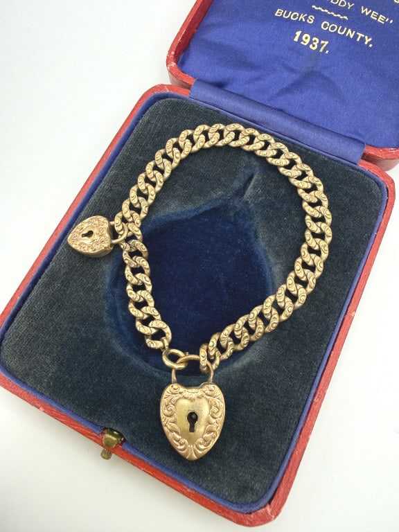 Antique Gold Filled Padlock Heart Charm Bracelet: Antique Gold Filled Padlock Heart Charm Bracelet having spring ring closure and two padlock charms, one marked F&B. Light wear throughout as shown. Closes with spring ring. Measuring approximately 7.2